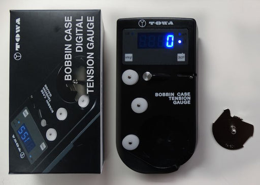 Towa® Digital Bobbin Case and Top Thread Tension Gauge with L-style bobbin insert for accurately measuring and adjusting embroidery machine thread tension.